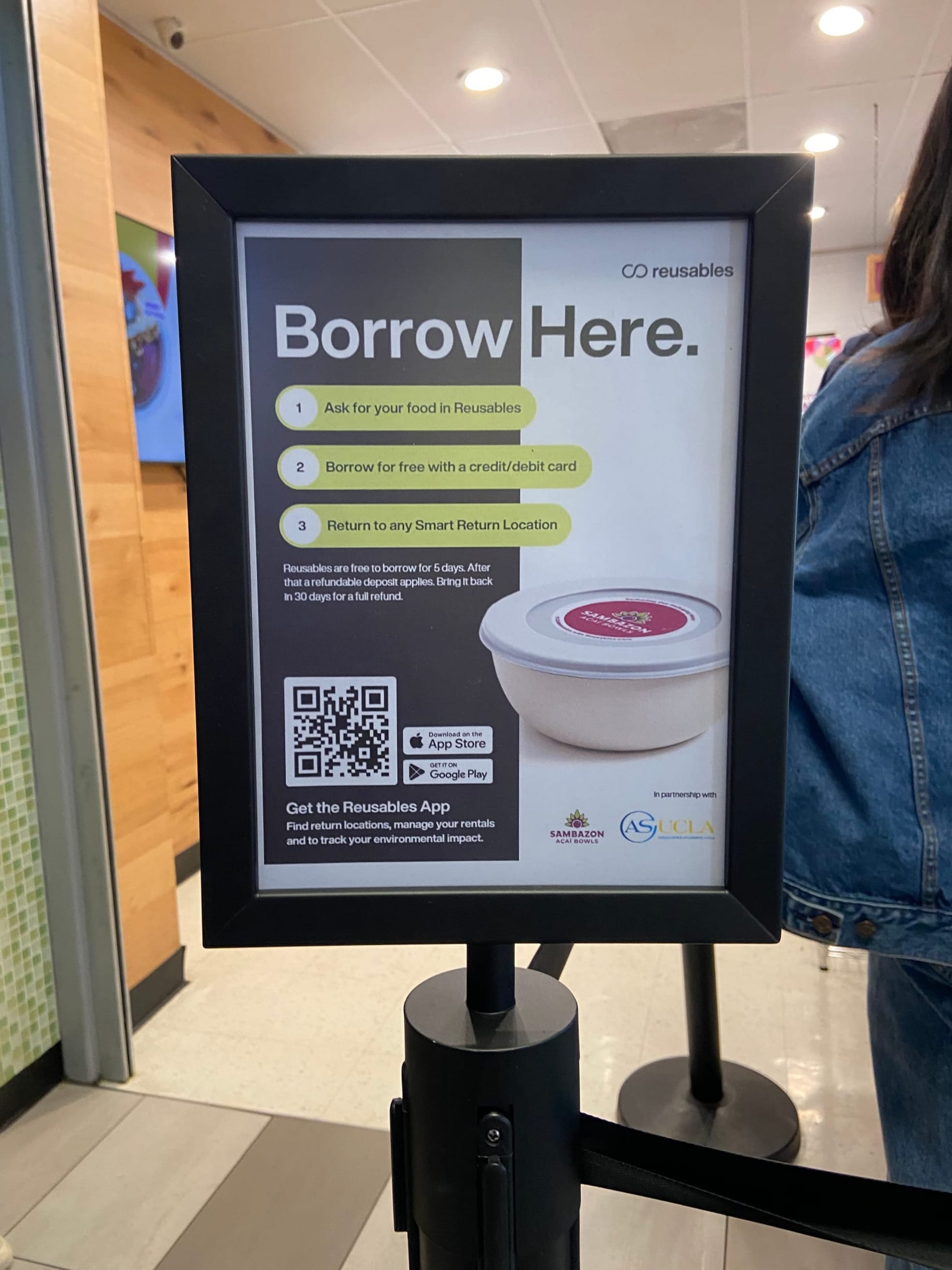 Sign explaining how to borrow a reusable bowl at Sambazon, in partnership with Reusables and ASUCLA